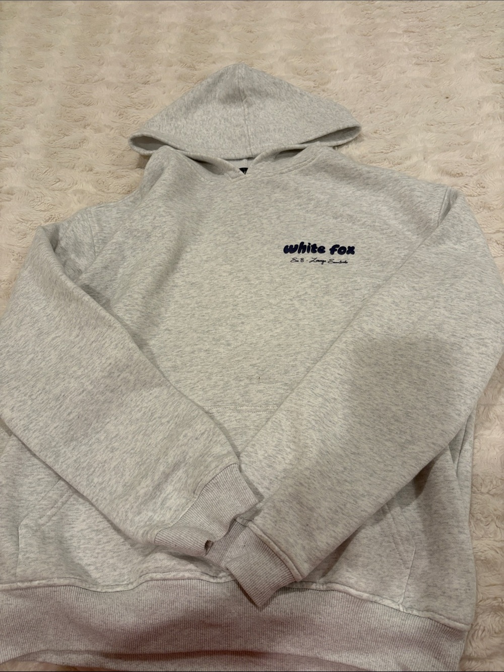 white fox hoodie with navy blue writing